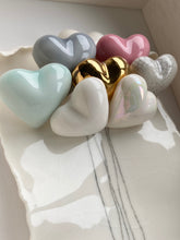Load image into Gallery viewer, Close up view of Always Together handmade porcelain wall piece with clustered hearts, including grey, pink, mint, gold lustre, white, and mother-of-pearl finishes