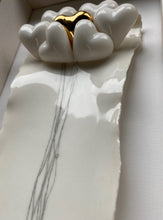 Load image into Gallery viewer, Close-up of a ceramic heart artwork with hand-finished white hearts and a 24 karat gold heart detail in a wooden box frame behind glass.