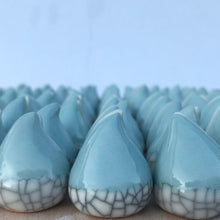 Load image into Gallery viewer, Blue and white Connemara Raindrops porcelain photo holders displayed with printed photographs on a blue background.