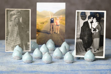 Load image into Gallery viewer, Connemara Raindrops porcelain photo holders displayed with printed photographs on a blue table.