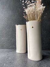 Load image into Gallery viewer, Two tall hand-built porcelain vases with small gold heart motifs, styled with dried flowers.