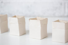 Load image into Gallery viewer, White handmade porcelain Boxeen tealight holder with a gold lustre rim, photographed in a clean, bright studio setting.