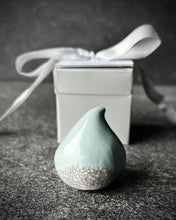 Load image into Gallery viewer, Connemara Raindrop porcelain photo holder with a blue glaze top and crackle-glazed white base, shown beside a gift box and ribbon.
