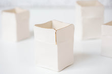 Load image into Gallery viewer, A white handmade porcelain Boxeen tealight holder with a gold lustre rim, shown in a close-up on a white surface.
