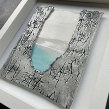Load image into Gallery viewer, Angled view of Written in the Stars framed porcelain wall piece with textured grey edges and a soft turquoise centre
