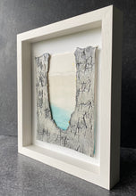 Load image into Gallery viewer, Framed Written in the Stars porcelain wall piece with a North Star motif, textured grey edges, and soft turquoise tones
